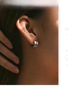 Close-up of S925 silver C-shaped earring with irregular texture on female model's ear