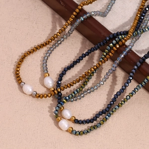 Detailed shot of dark crystal beads and freshwater pearls on a retro steel chain