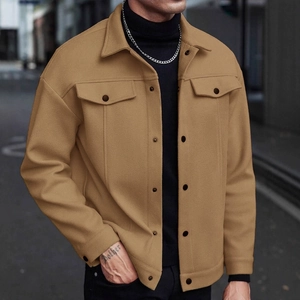 Detail of camel wool jacket with lapel collar and flap pockets in urban style