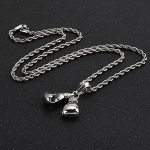 Macro shot of polished stainless steel boxing glove pendant with realistic hip hop details