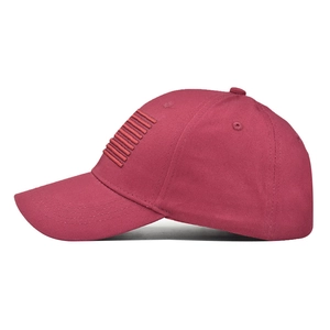 Close-up of red washed cotton baseball cap featuring thick embroidered stripes on side