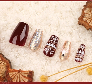Macro view of Christmas coffin press-on nails with red reindeer and glitter designs