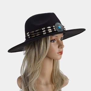 Close-up of black wide brim fedora hat with turquoise bead and silver buckle detail