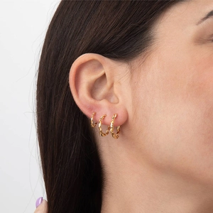 Three-piece set of twisted gold hoop earrings in various sizes for stylish women