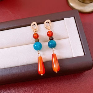 Bohemian drop earrings featuring multi-colored beads and a translucent teardrop pendant