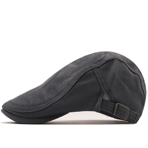 Detail view of breathable black mesh trucker hat with adjustable metal buckle on side