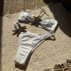 Detailed view of 3D starfish sequin embroidery on high-quality white bikini fabric