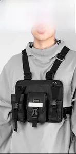 Detailed view of black tactical chest bag featuring multiple pockets and quick-release buckles
