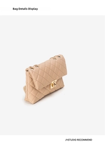 Detailed close-up of beige quilted crossbody bag with gold chain and twist-lock buckle