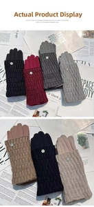Detail of winter knit gloves with wavy cuffs and a sparkling rhinestone floral button