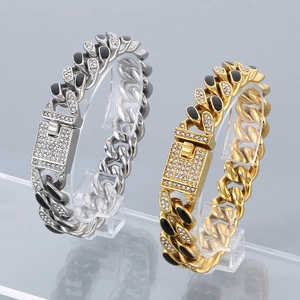 Detail of silver and gold hip hop Cuban bracelets with black enamel and crystal clasp