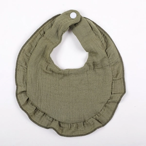 Detail of sage green ruffled muslin bib showing soft double-layer cotton gauze texture