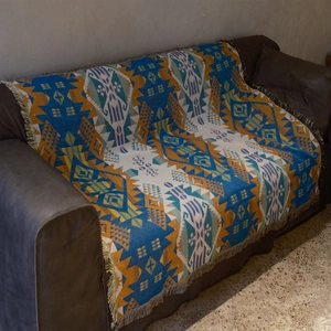 Close-up of Bohemian knit blanket featuring ethnic geometric patterns and tassel details