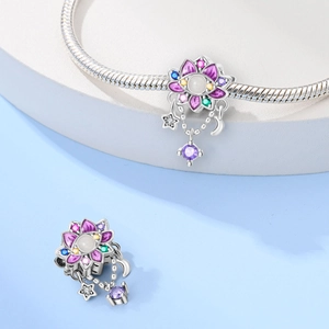 Detailed macro of a 925 silver dreamcatcher charm with purple enamel and gemstones