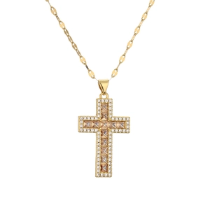 Close-up of golden cross pendant necklace featuring shimmering micro-pave cubic zirconia