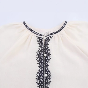 Creamy white women shirt with intricate black ethnic embroidery and cotton texture