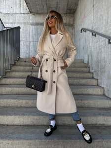 Detail of a beige mid-length wool coat featuring classic lapels and double-breasted buttons