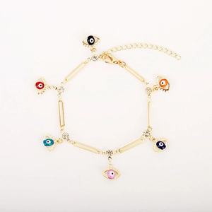 Gold evil eye bracelet featuring colorful star-shaped charms with sparkling crystals