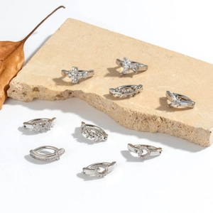 Silver navel piercing belly rings with crystal charms like hearts, moons and butterflies