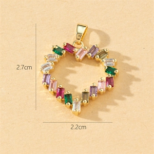 Detailed view of gold heart pendant with colorful zircon stones measuring 2.7cm by 2.2cm