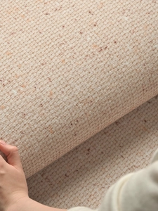 Close-up of beige woven carpet texture and flexible thickness with checkered pattern