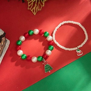 Detail view of two-piece Christmas charm bracelet set with Santa and tree pendants