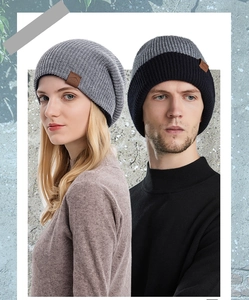 Detail shot of winter knit beanie with leather logo patch and soft ribbed texture fabric