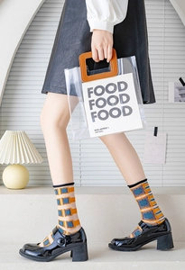 Detail of color-block geometric patterned socks paired with black patent leather Mary Janes