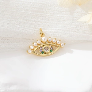 Macro detail of gold evil eye pendant with vibrant zirconia stones and pearl accents