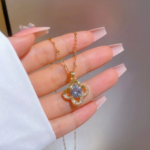 Luxurious gold clover necklace with sparkling micro-pave crystals and zircon stone