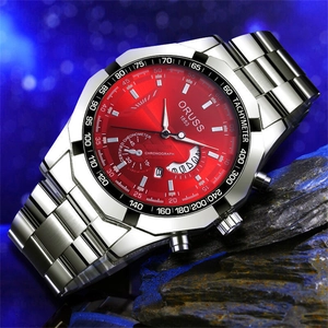 Macro shot of Oruss business watch with red dial and steel strap on dark rock texture