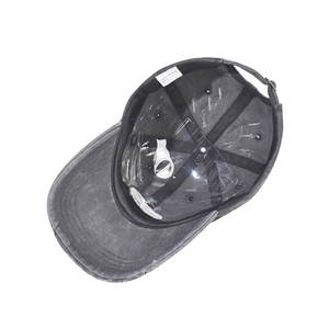Detailed inner view of washed grey cotton baseball cap with labels and adjustable strap