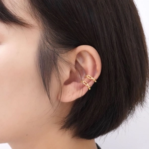 Golden chain link ear cuffs set with micro diamonds shown on ear in a close-up profile