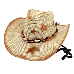 Detail of woven straw cowboy hat with ethnic beads and star pattern for sun protection