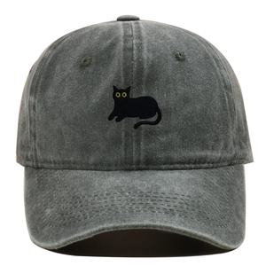 Close-up of black cat embroidery and yellow eyes on washed dark gray baseball cap