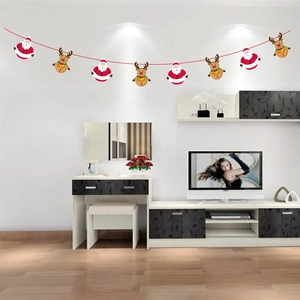 Christmas bunting with Santa Claus and reindeer characters hanging on a living room wall