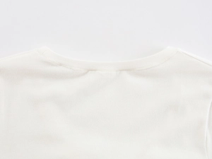 Detailed close-up of white U-neck cotton T-shirt featuring reinforced double stitching