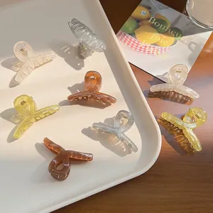 Translucent jelly colors small shark hair clips set with cross design in soft morning light