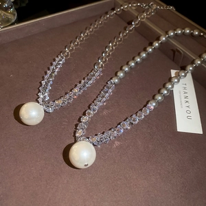Detailed view of gray pearl pendant necklaces with sparkling crystal beaded chains