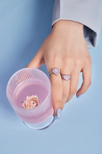 Close-up of S925 silver heart rings with purple zircon and colorful pavé stones on hand