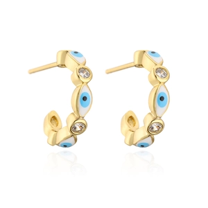 Detail of 18K gold-plated C-shaped earrings with blue evil eye enamel and cubic zirconia