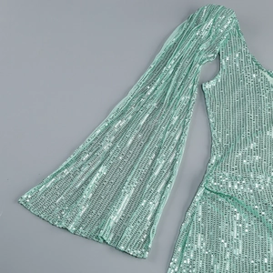 Detailed macro view of mint green sequins on elegant evening dress sleeve and waist