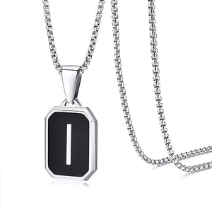 Detailed close-up of octagonal letter I pendant with black inlay on box chain