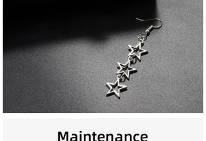 Detail shot of silver triple hollow star drop earrings with polished metallic finish