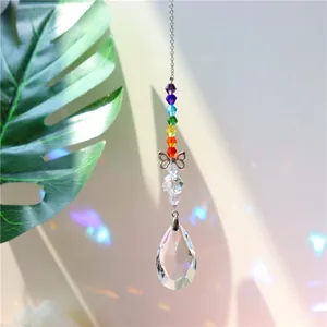 Rainbow crystal suncatcher with butterfly accent and teardrop prism producing light refraction