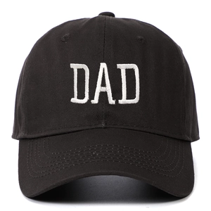 Detail of white DAD embroidery on a black cotton baseball cap with twill texture