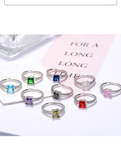 Detailed collection of square princess cut rings in multiple colors on a chic pink card