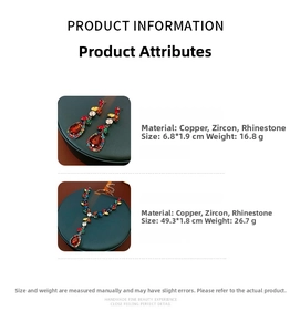 Detail of luxury teardrop necklace and earrings set with red zircons and multi-color rhinestones