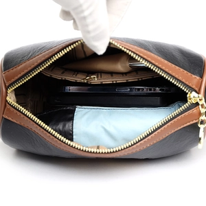Vintage Chinese style shoulder bag showing interior compartments and gold zipper detail