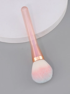 Detail of soft fluffy makeup brush with pink and blue gradient bristles and rose gold ferrule
